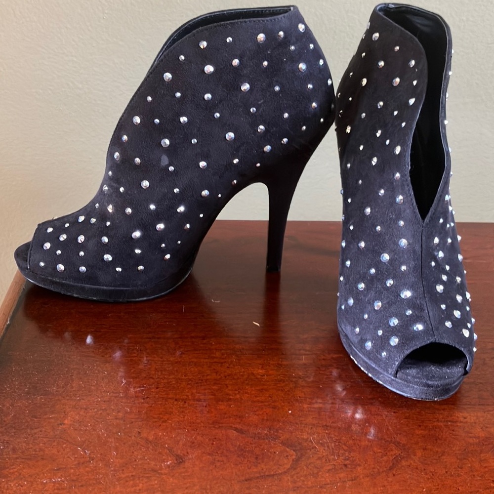 Black high heeled boots, sparkles.